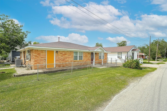 single story home featuring central air condition unit and a front yard