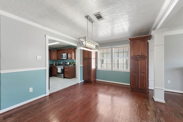 unfurnished dining area with ornate columns, ornamental molding, hardwood / wood-style flooring, and a textured ceiling