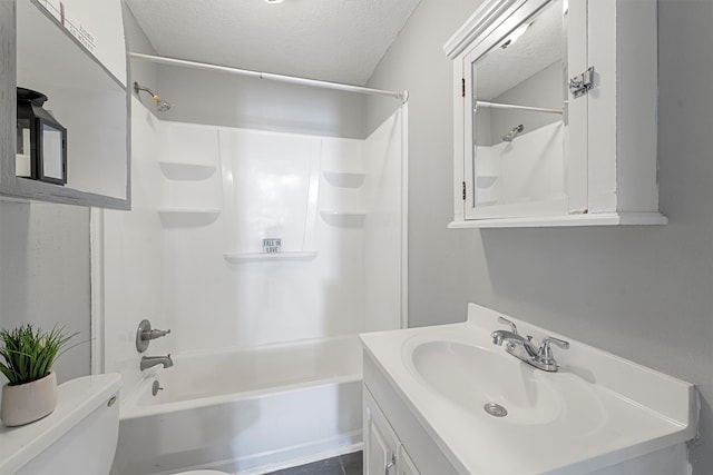 full bathroom featuring vanity, shower / washtub combination, a textured ceiling, and toilet