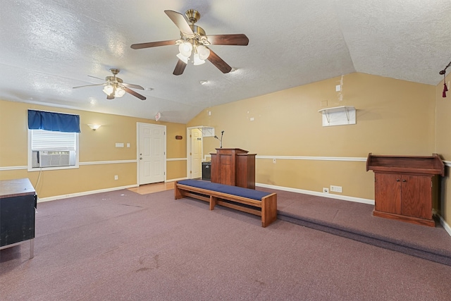 interior space with lofted ceiling, ceiling fan, carpet, and a textured ceiling