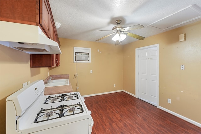 kitchen featuring ceiling fan, sink, a textured ceiling, white range with gas stovetop, and dark hardwood / wood-style flooring