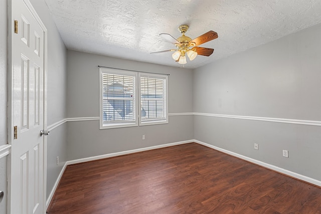 empty room featuring ceiling fan, dark hardwood / wood-style floors, and a textured ceiling