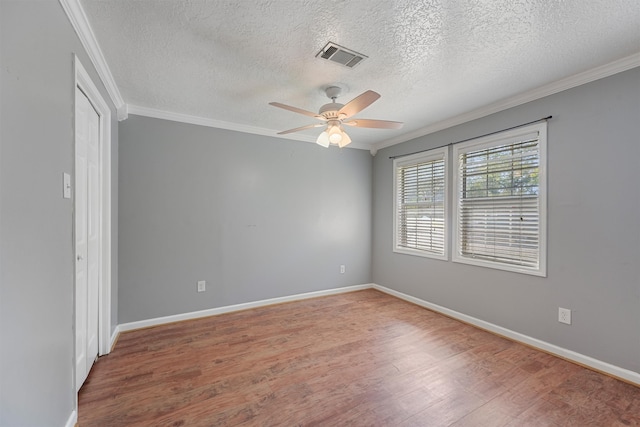 empty room featuring wood-type flooring, a textured ceiling, and ceiling fan