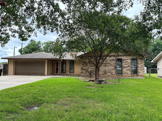 ranch-style home featuring a front yard and a garage