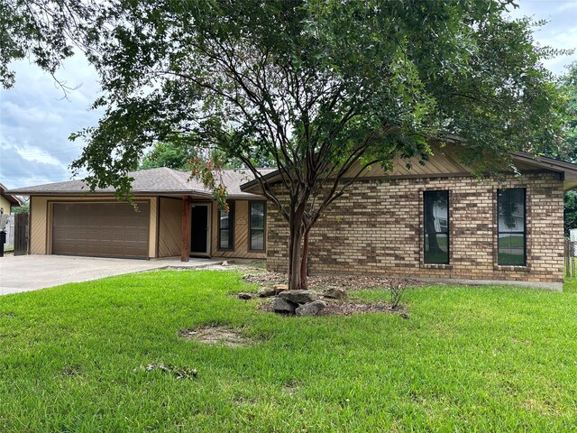 ranch-style home featuring a garage and a front lawn