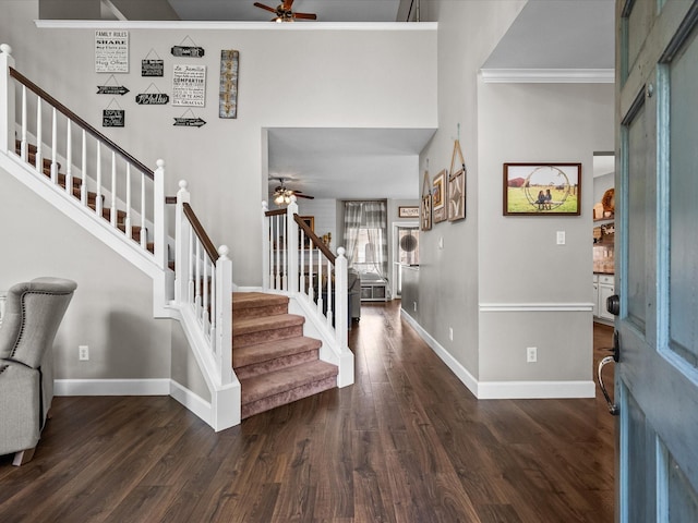 entrance foyer featuring baseboards, stairway, a ceiling fan, and wood finished floors