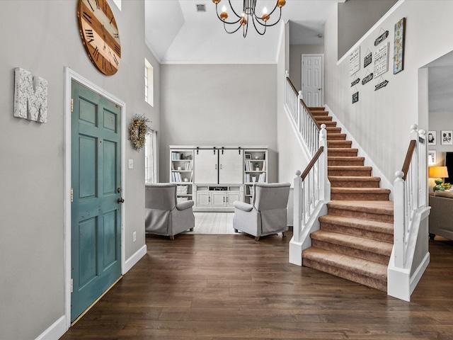 foyer featuring stairs, a high ceiling, and wood finished floors