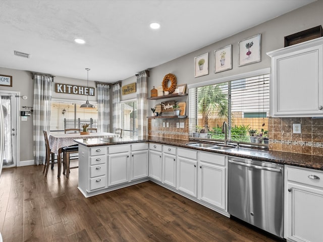 kitchen featuring a wealth of natural light, visible vents, dishwasher, and a sink