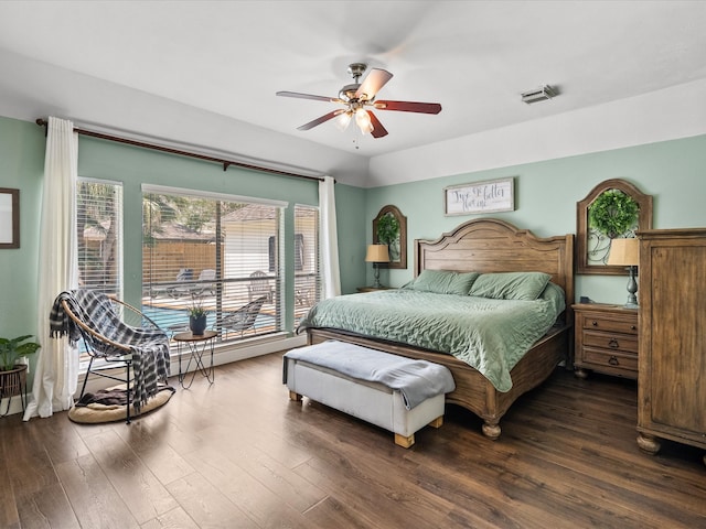 bedroom with dark wood-style floors, ceiling fan, and visible vents