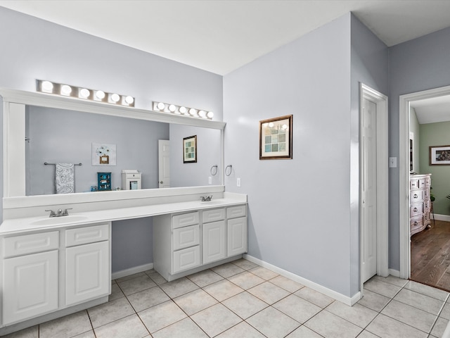 bathroom with double vanity, a sink, and tile patterned floors