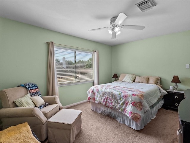 carpeted bedroom with visible vents, ceiling fan, and baseboards