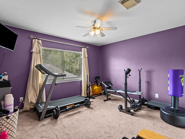 workout room with carpet floors, ceiling fan, and visible vents