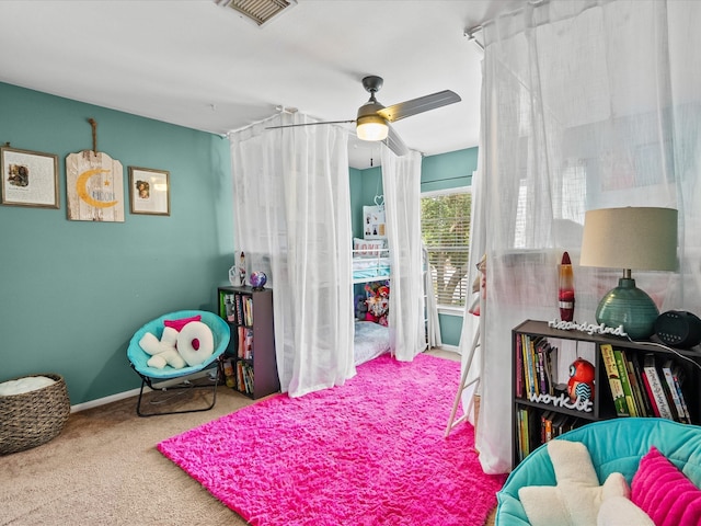 carpeted bedroom featuring a ceiling fan, visible vents, and baseboards