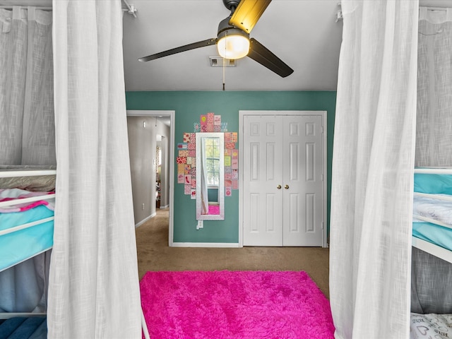 bedroom featuring baseboards, visible vents, ceiling fan, carpet, and a closet