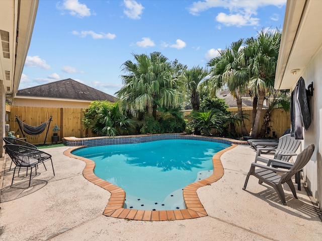 view of swimming pool with a patio area, a fenced backyard, and a fenced in pool