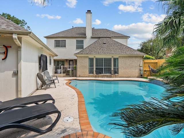 view of swimming pool with a patio area, fence, and a fenced in pool