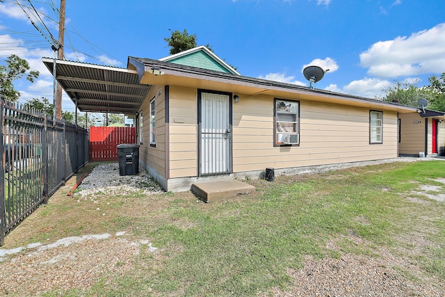 back of property with a lawn and cooling unit