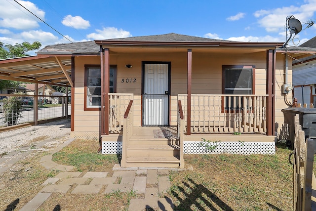 bungalow featuring a carport and a porch