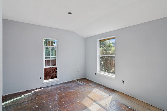 unfurnished room featuring hardwood / wood-style flooring and vaulted ceiling