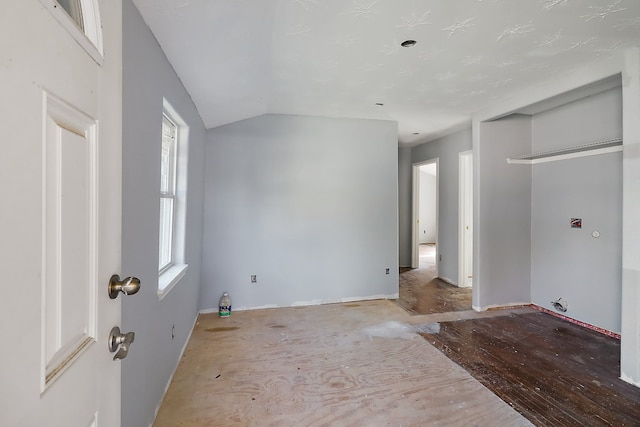 interior space with light hardwood / wood-style floors, lofted ceiling, and a wealth of natural light