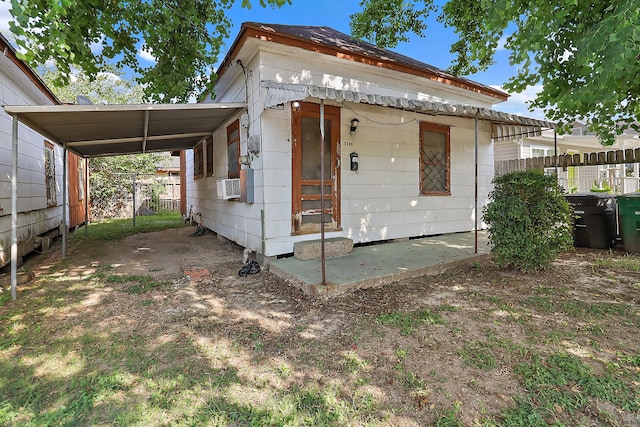 view of front of house featuring cooling unit and a carport