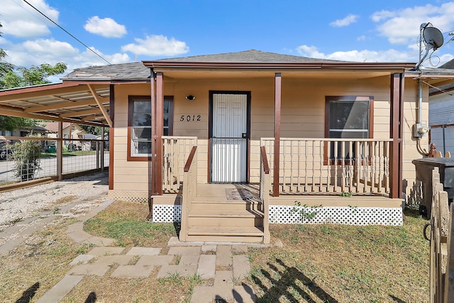 view of front of home with a carport and a porch