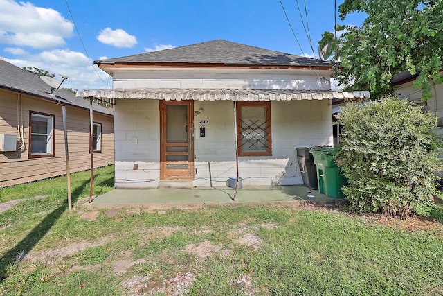 view of front of house featuring covered porch and a front yard