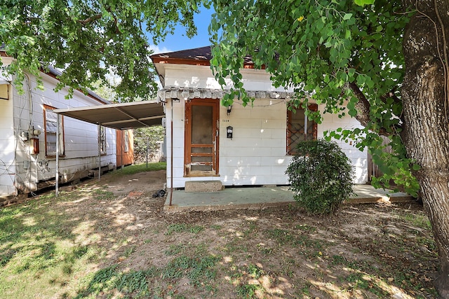 rear view of property featuring a carport