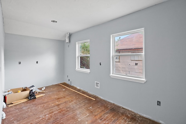 empty room with hardwood / wood-style flooring