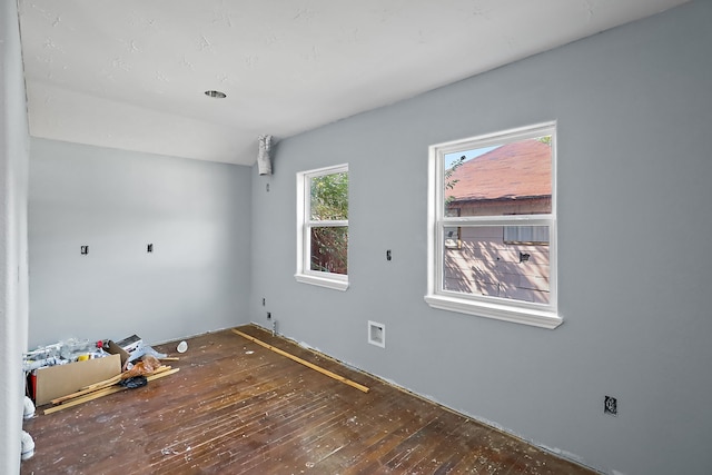 unfurnished room with dark hardwood / wood-style flooring