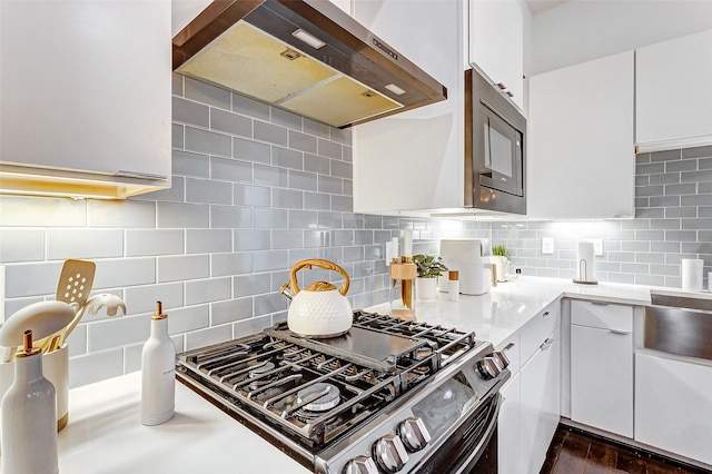 kitchen with white cabinetry, wall chimney range hood, black appliances, backsplash, and dark hardwood / wood-style flooring