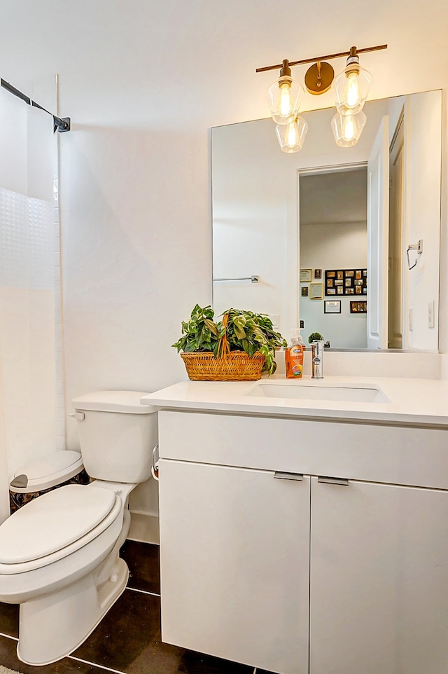 bathroom featuring walk in shower, tile patterned flooring, vanity, and toilet