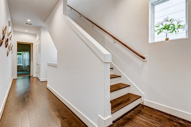 stairs featuring wood-type flooring