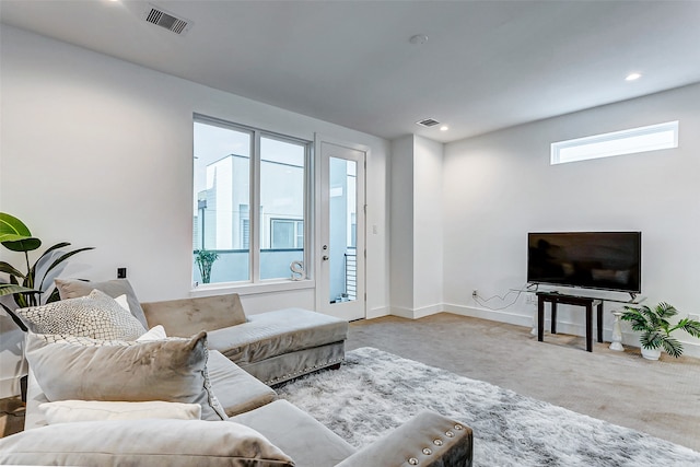 living room featuring a healthy amount of sunlight and light carpet