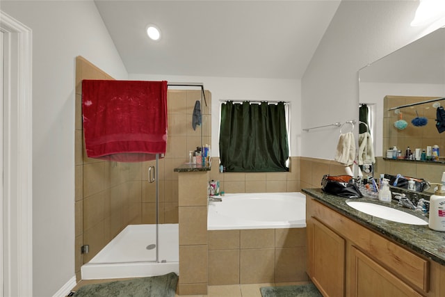 bathroom featuring independent shower and bath, vanity, lofted ceiling, and tile patterned flooring