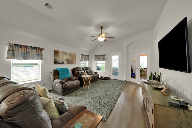 living room featuring a healthy amount of sunlight, vaulted ceiling, ceiling fan, and hardwood / wood-style flooring