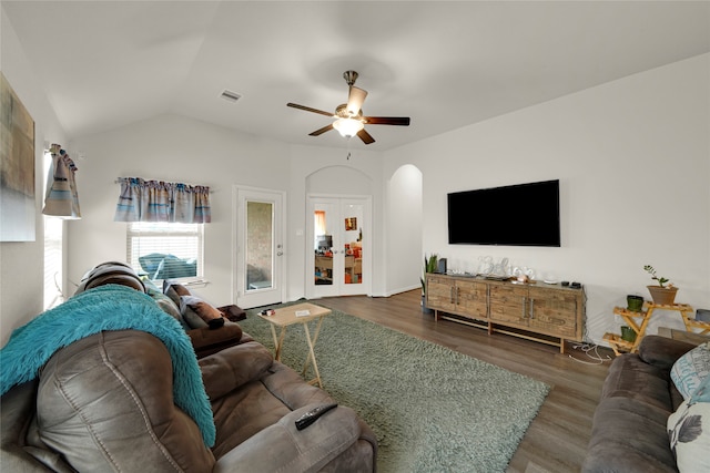 living room with ceiling fan, lofted ceiling, and dark hardwood / wood-style flooring