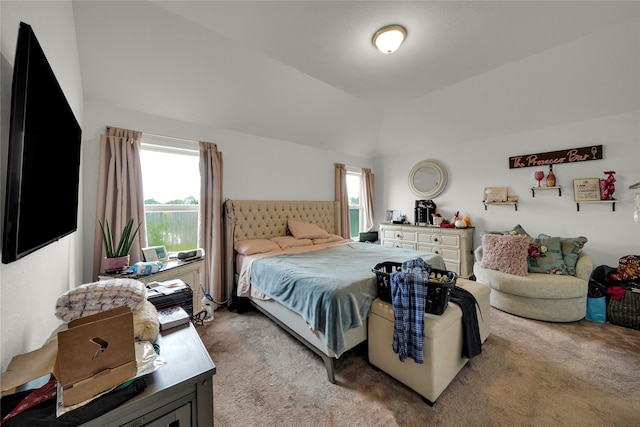 bedroom featuring vaulted ceiling and light colored carpet