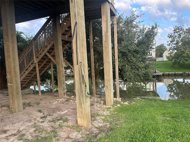 view of yard with a deck with water view