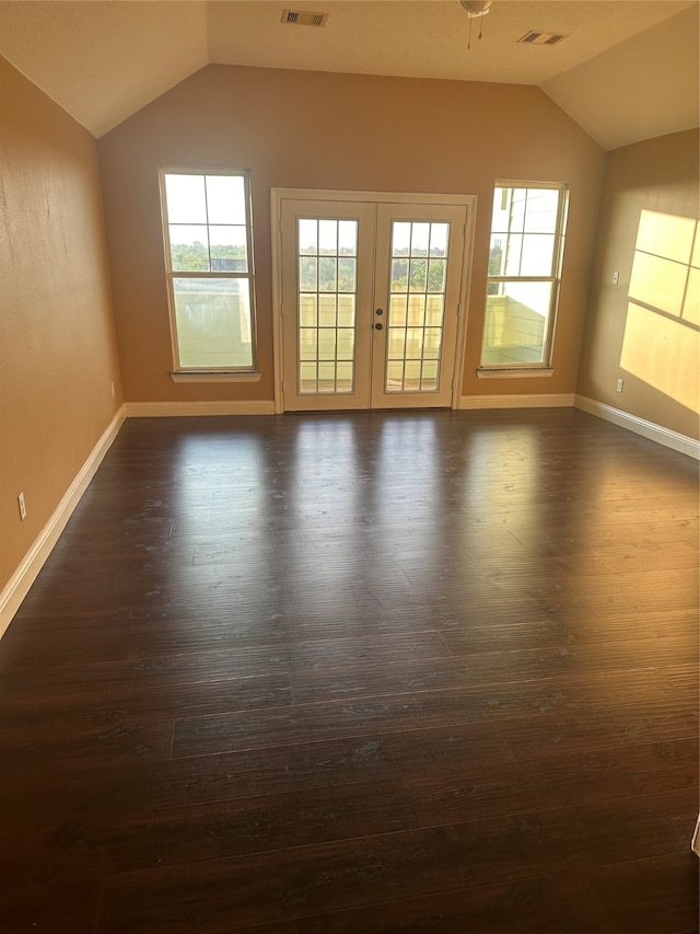 empty room with french doors, dark hardwood / wood-style floors, and vaulted ceiling