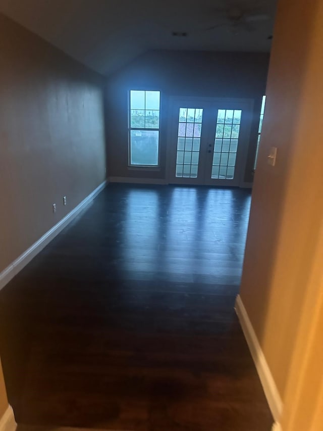 empty room featuring lofted ceiling and dark hardwood / wood-style flooring