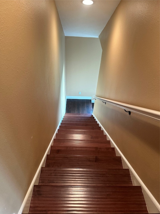 stairway with hardwood / wood-style floors