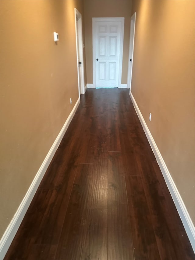 corridor with dark hardwood / wood-style floors