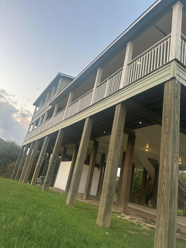 rear view of house featuring a yard