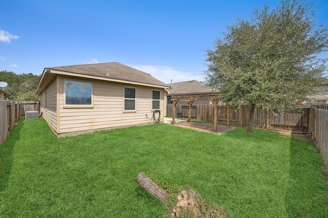 back of house featuring a yard, a patio area, and a pergola