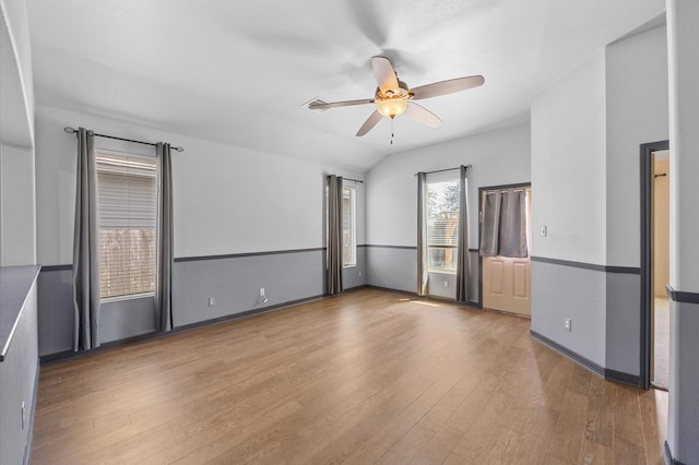 spare room with lofted ceiling, hardwood / wood-style flooring, and ceiling fan