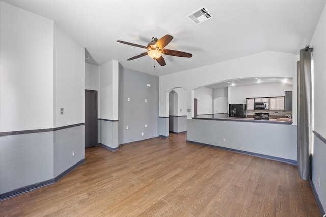 unfurnished living room with ceiling fan and wood-type flooring