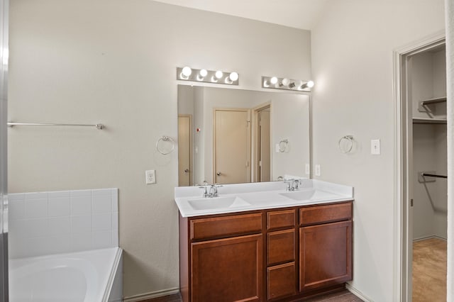 bathroom featuring vanity and a tub to relax in