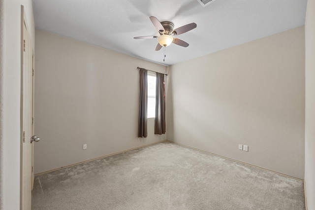 empty room with light colored carpet and ceiling fan