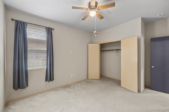 unfurnished bedroom with a closet, ceiling fan, and light colored carpet